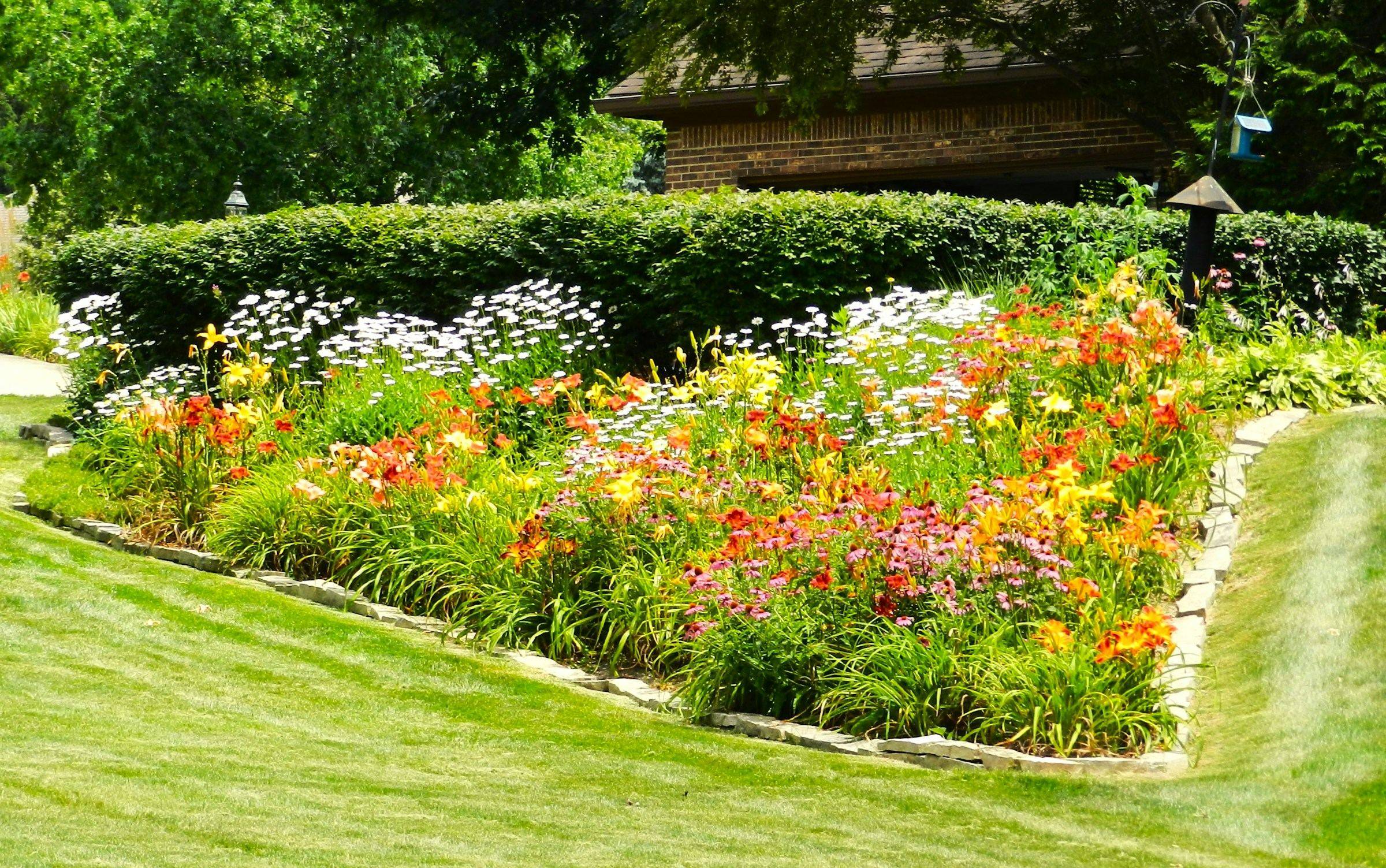 Colorful flower bed beside a freshly edged lawn