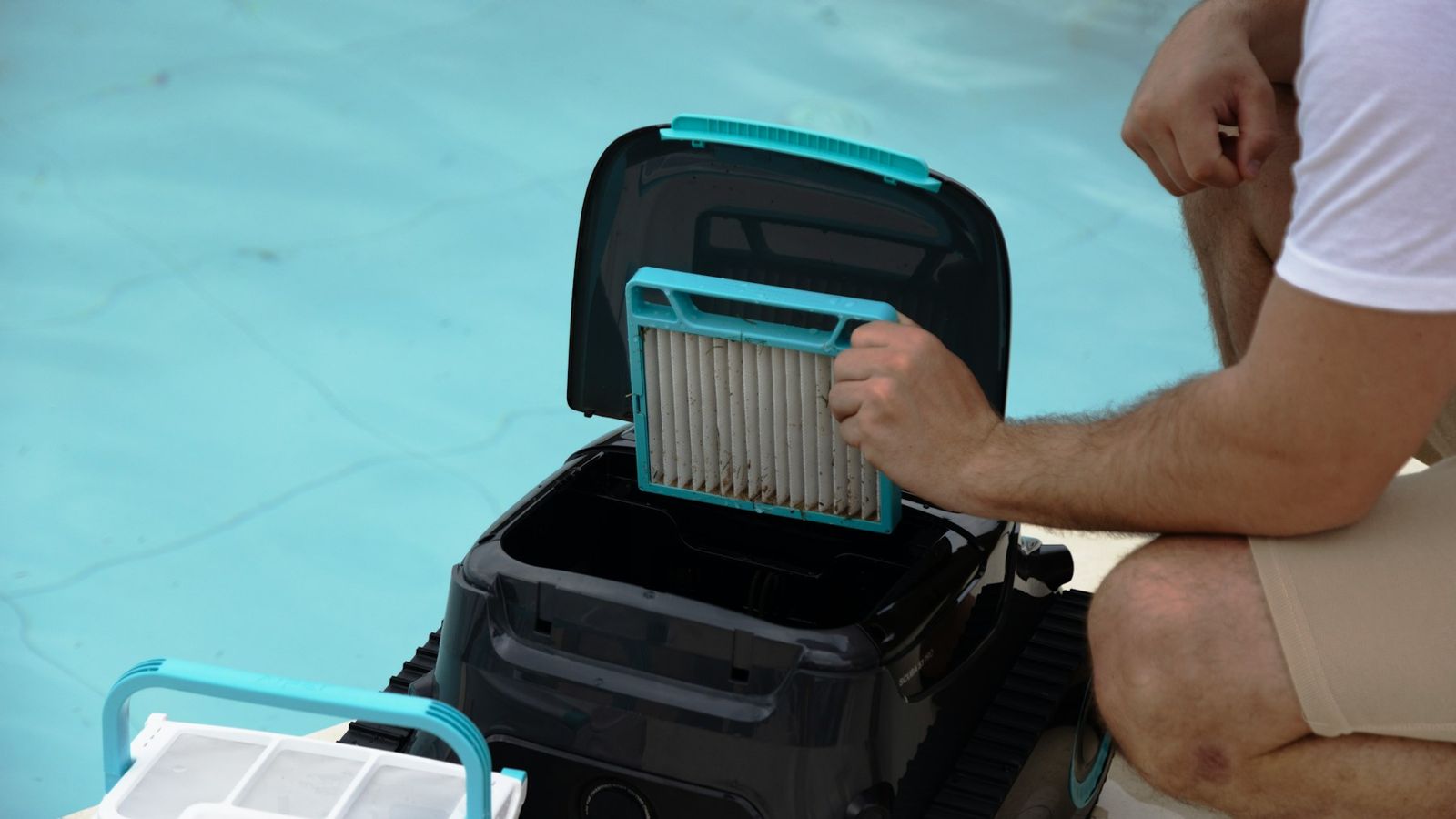 Technician cleaning the filter of a pool cleaner